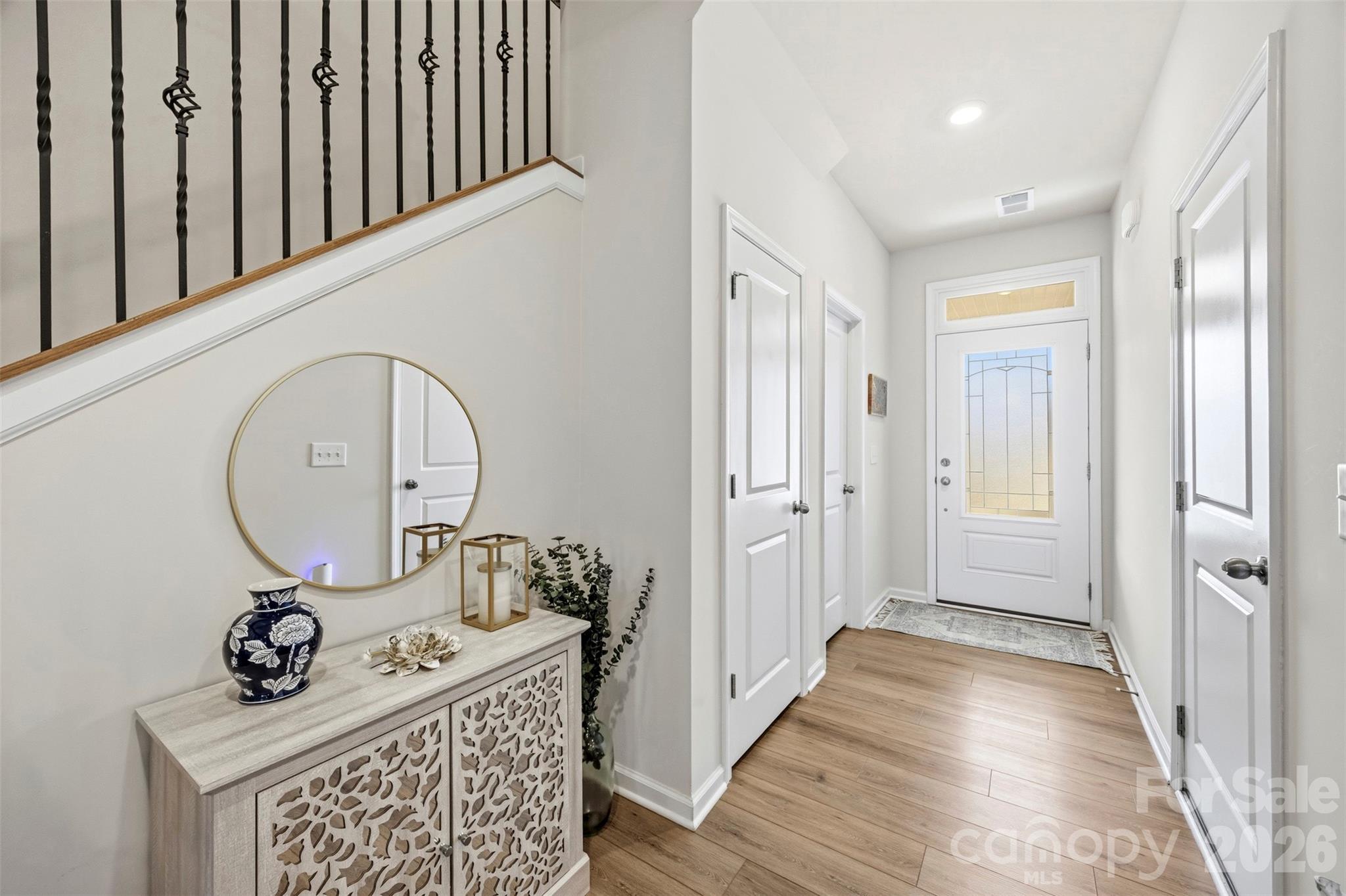 5030 Moss Pne Way Fort Mill, SC 29708 - Photo 7 of 28 a view of a hallway with wooden floor and a sink