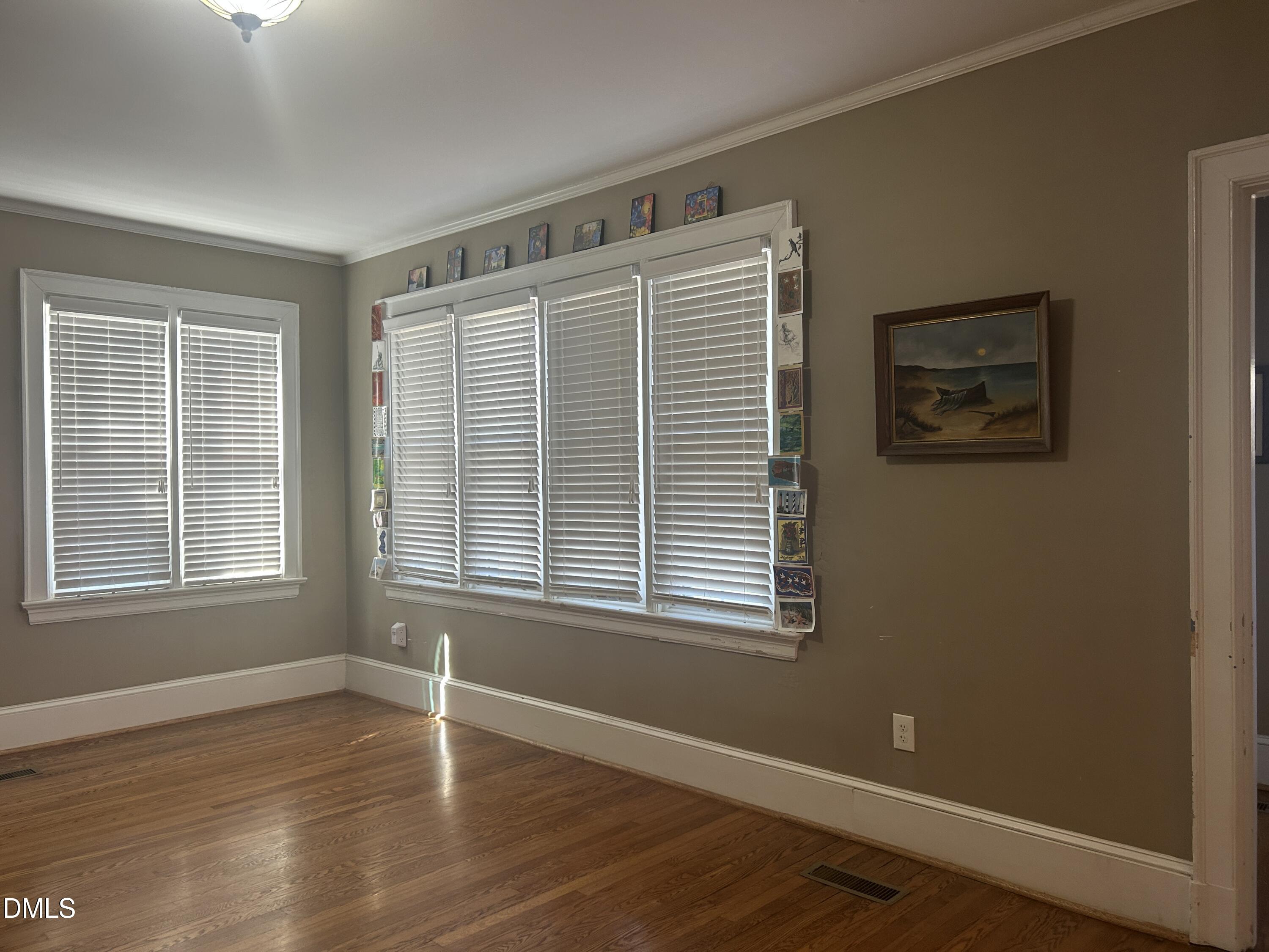 405 Sunset Avenue Clinton, NC 28328 - Photo 12 of 47 an empty room with wooden floor and windows