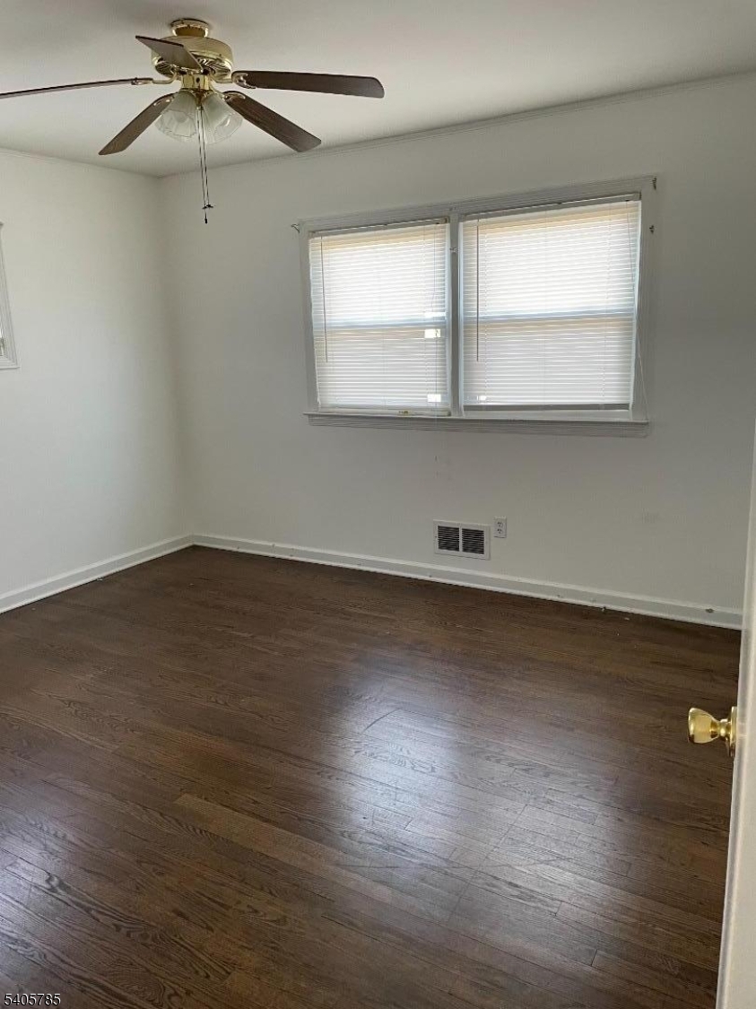 31 Kingston Road Parsippany, NJ 07054 - Photo 7 of 15 an empty room with wooden floor and windows