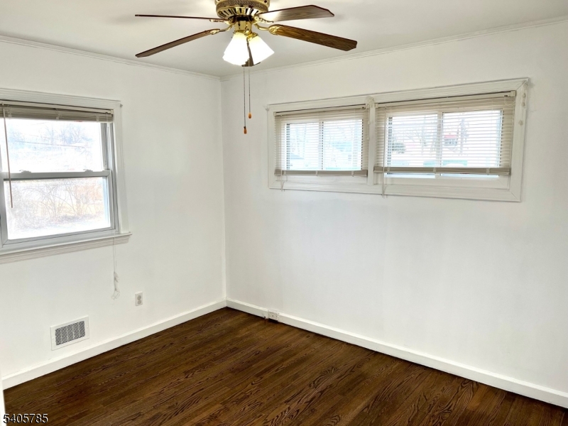 31 Kingston Road Parsippany, NJ 07054 - Photo 9 of 15 a view of an empty room with wooden floor and a window