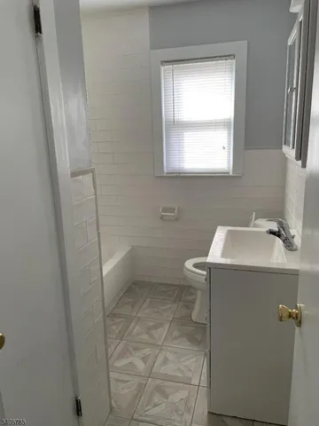 a bathroom with a sink toilet and tub