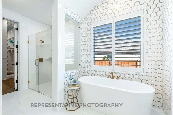 a white bath tub sitting next to a white sink