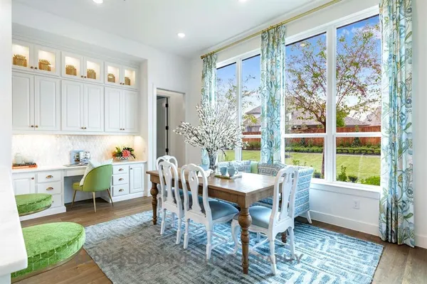 a view of a dining room with furniture window and wooden floor