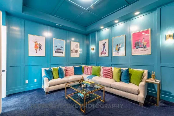 a living room with furniture and wall paintings
