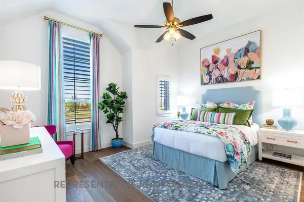 a bedroom with a bed a dresser and a painting on the wall