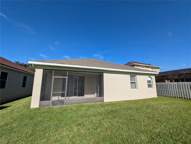 a view of a house with backyard and porch