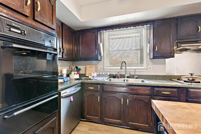 a kitchen with a sink stove and cabinets