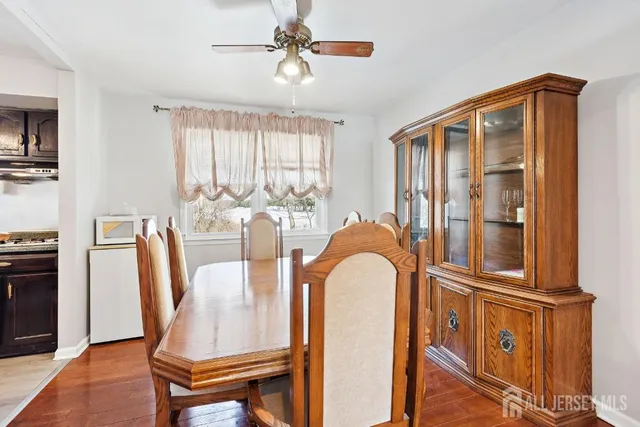 a living room with furniture a flat screen tv and a window