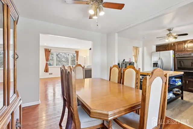 a dining room with furniture and wooden floor