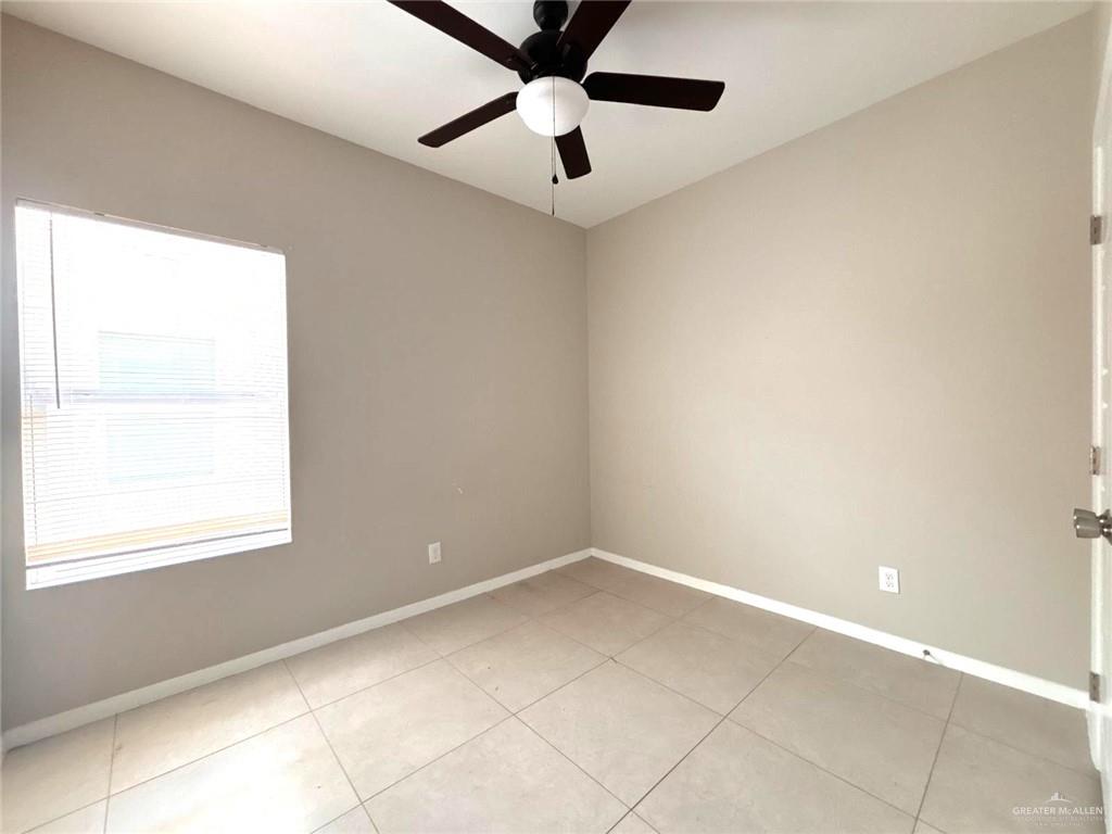 1405 Alta Vista Drive, Unit 4 Weslaco, TX 78596 - Photo 12 of 15 Spare room featuring a ceiling fan and light tile patterned floors