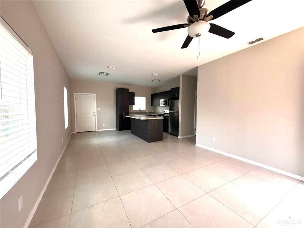 1405 Alta Vista Drive, Unit 4 Weslaco, TX 78596 - Photo 15 of 15 Kitchen featuring freestanding refrigerator, open floor plan, a center island, light countertops, and light tile patterned floors