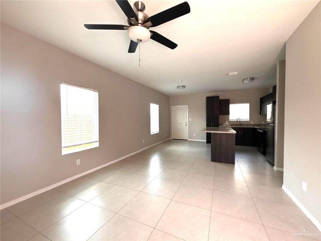 1405 Alta Vista Drive, Unit 4 Weslaco, TX 78596 - Photo 2 of 15 Unfurnished living room with plenty of natural light, light tile patterned floors, and ceiling fan