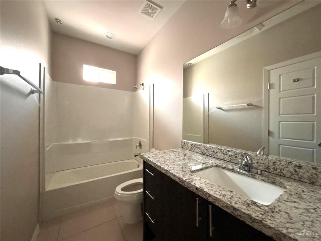 1405 Alta Vista Drive, Unit 4 Weslaco, TX 78596 - Photo 8 of 15 Full bathroom featuring vanity, shower combination, and tile patterned flooring