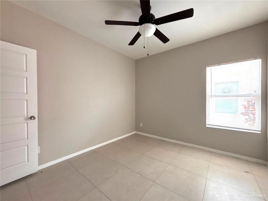 1405 Alta Vista Drive, Unit 4 Weslaco, TX 78596 - Photo 9 of 15 Empty room featuring light tile patterned floors and a ceiling fan