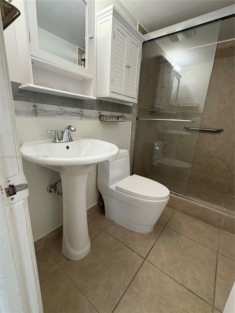 600 Northeast 36th Street, Unit 714 Miami, FL 33137 - Photo 9 of 10 a bathroom with a sink a toilet and shower