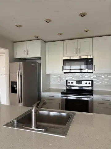 a kitchen with stainless steel appliances and a sink