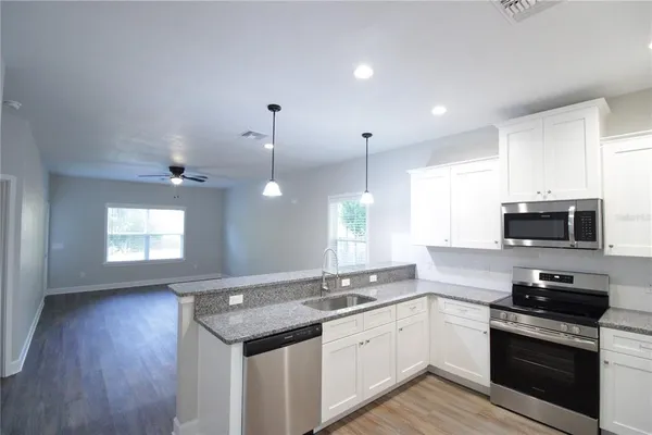 a kitchen with a sink stove and microwave