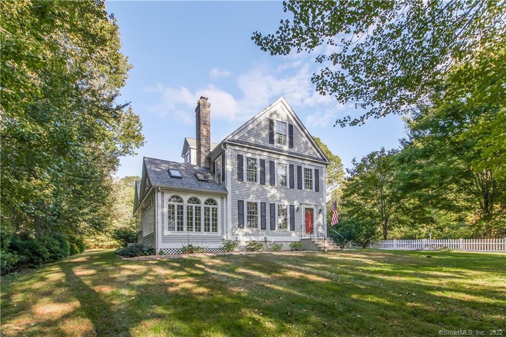 60 Shore Road Old Lyme, CT 06371 - Photo 1 of 1 a front view of a house with a garden