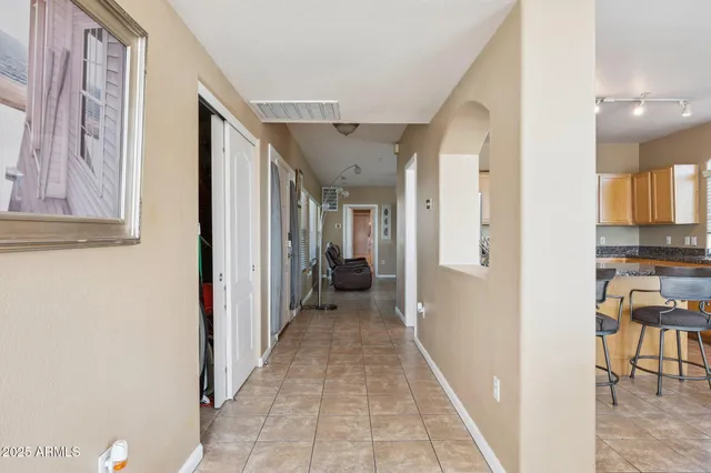 a view of a hallway with furniture and a window