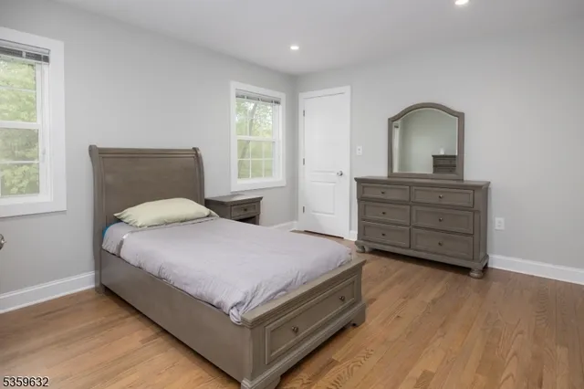 a bedroom with a bed and a dresser