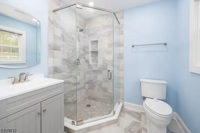 a bathroom with a shower a toilet and sink