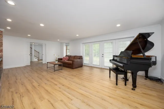 a living room with furniture and a piano