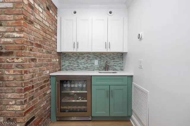 a kitchen with granite countertop a sink and a vanity