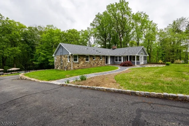 a view of house with a yard and potted plants