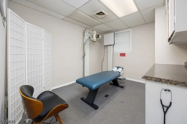 a living room with furniture and a air conditioner vent