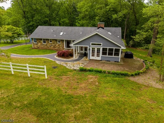 a front view of a house with a yard table and chairs