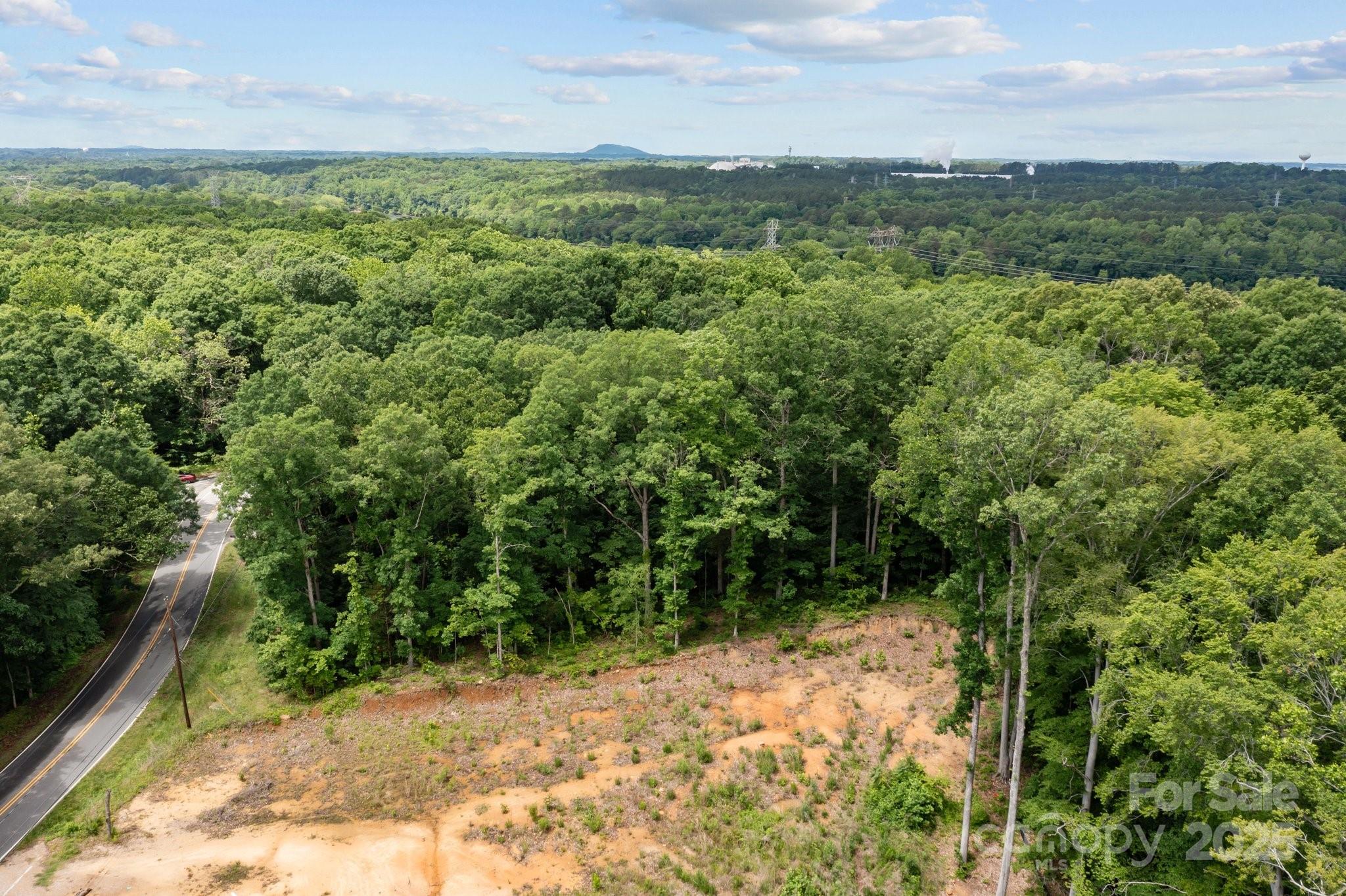 1607 Hart Road Charlotte, NC 28214 - Photo 12 of 14 a view of a forest with trees in the background