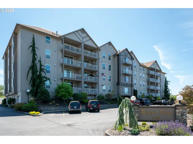 a kitchen with stainless steel appliances granite countertop a dining table and chairs