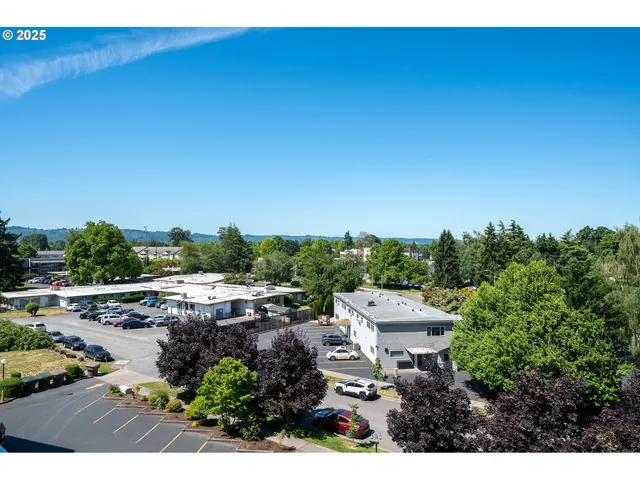 a living room with lots of furniture and painting on the wall