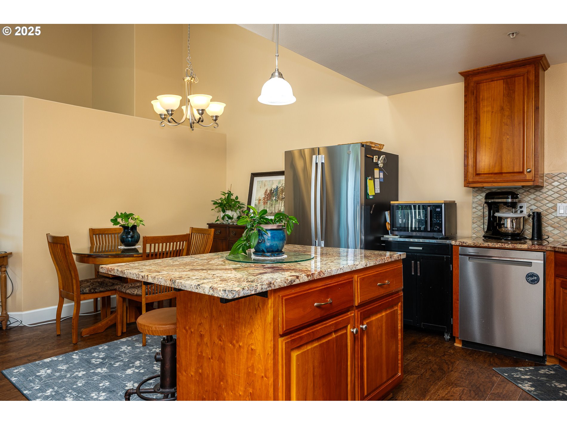 1548 River Road, Unit 401 Longview, WA 98632 - Photo 2 of 34 a kitchen with stainless steel appliances granite countertop a dining table and chairs