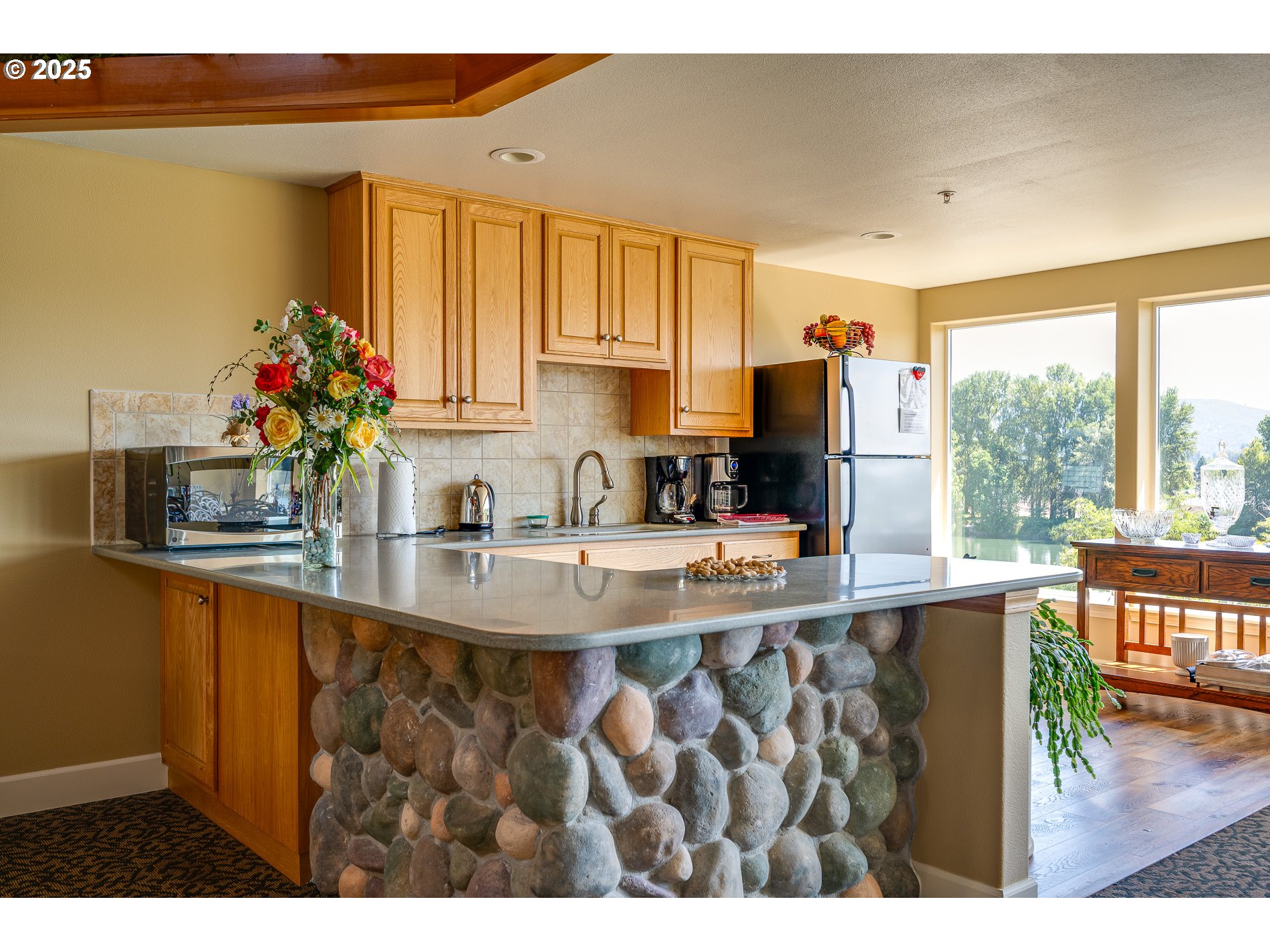 1548 River Road, Unit 401 Longview, WA 98632 - Photo 21 of 34 a kitchen with a sink a counter top space and living room area