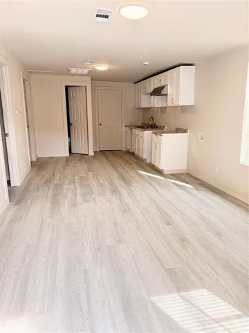 a view of a kitchen with a sink and a refrigerator