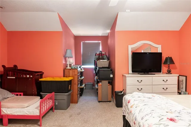 a bedroom with a bed and glass door