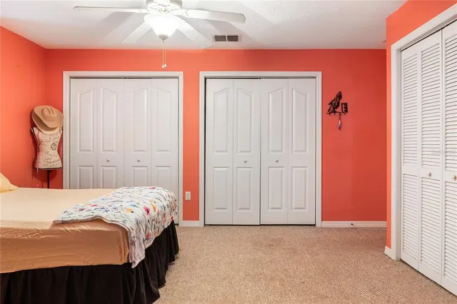 a bedroom with a bed and a lamp with the dresser