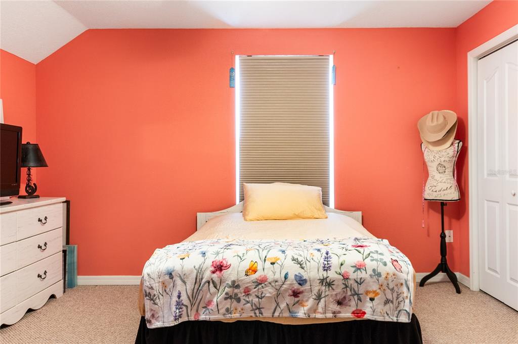 7290 Northeast 106 Terrace Bronson, FL 32621 - Photo 15 of 40 a bedroom with a bed and a lamp with the dresser