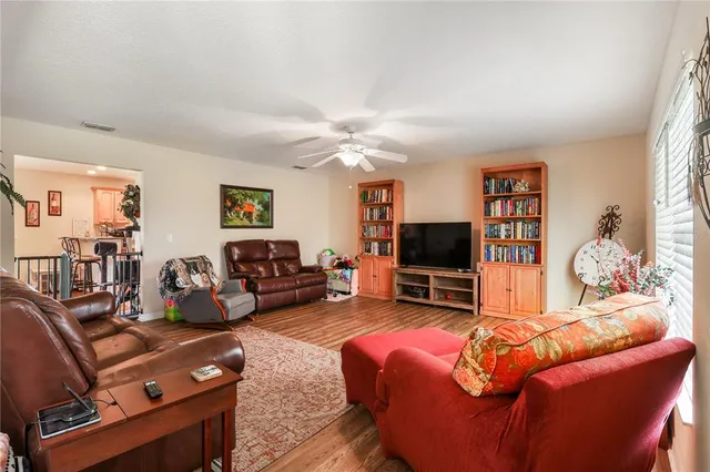 a living room with furniture a window and a flat screen tv