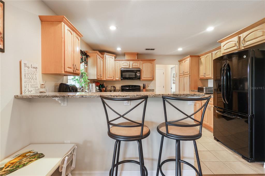 7290 Northeast 106 Terrace Bronson, FL 32621 - Photo 20 of 40 a kitchen with stainless steel appliances granite countertop a stove a sink and a refrigerator