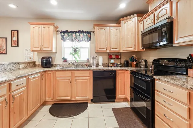 a kitchen with a sink refrigerator and cabinets