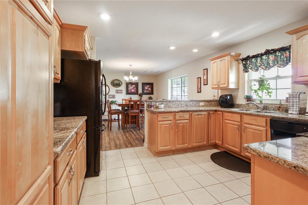 7290 Northeast 106 Terrace Bronson, FL 32621 - Photo 22 of 40 a kitchen with a sink refrigerator and cabinets