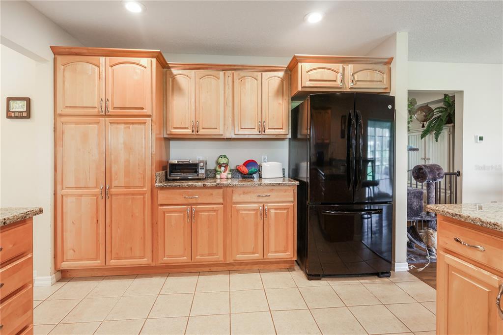 7290 Northeast 106 Terrace Bronson, FL 32621 - Photo 23 of 40 a kitchen with stainless steel appliances granite countertop a refrigerator and a sink