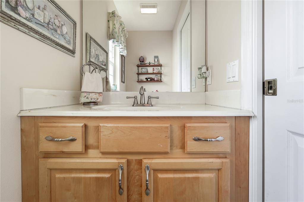 7290 Northeast 106 Terrace Bronson, FL 32621 - Photo 25 of 40 a bathroom with a sink and a mirror