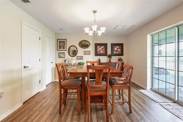 a view of a dining room with furniture wooden floor and a chandelier