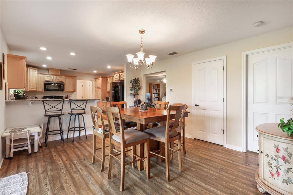 7290 Northeast 106 Terrace Bronson, FL 32621 - Photo 29 of 40 a view of a dining room with furniture and wooden floor