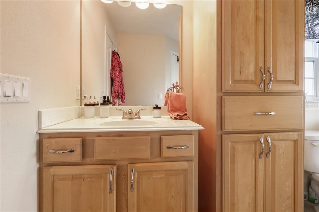 7290 Northeast 106 Terrace Bronson, FL 32621 - Photo 35 of 40 a bathroom with a sink and a mirror