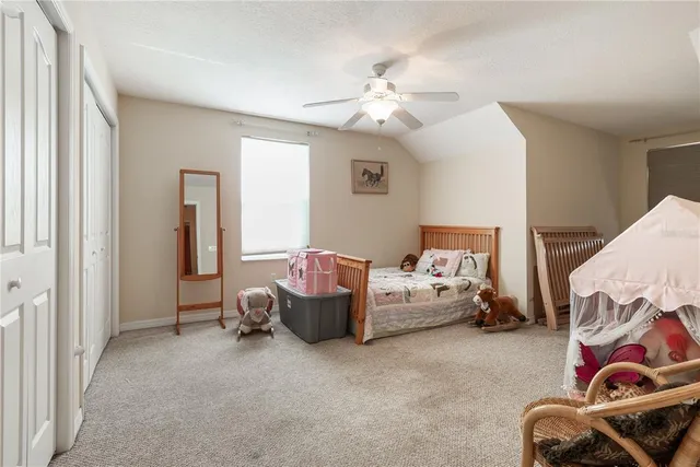 a bedroom with bed and a couch