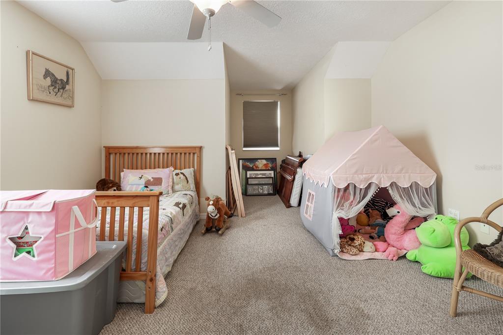 7290 Northeast 106 Terrace Bronson, FL 32621 - Photo 40 of 40 a bedroom with bed and a couch